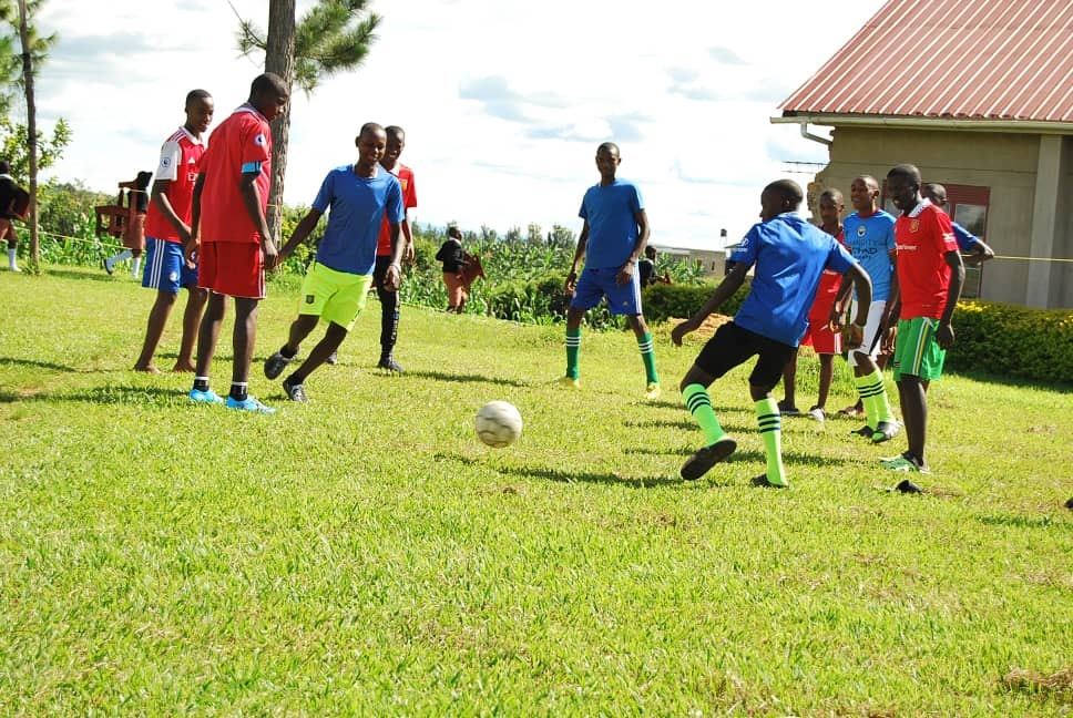 Students playing football on the school sports field